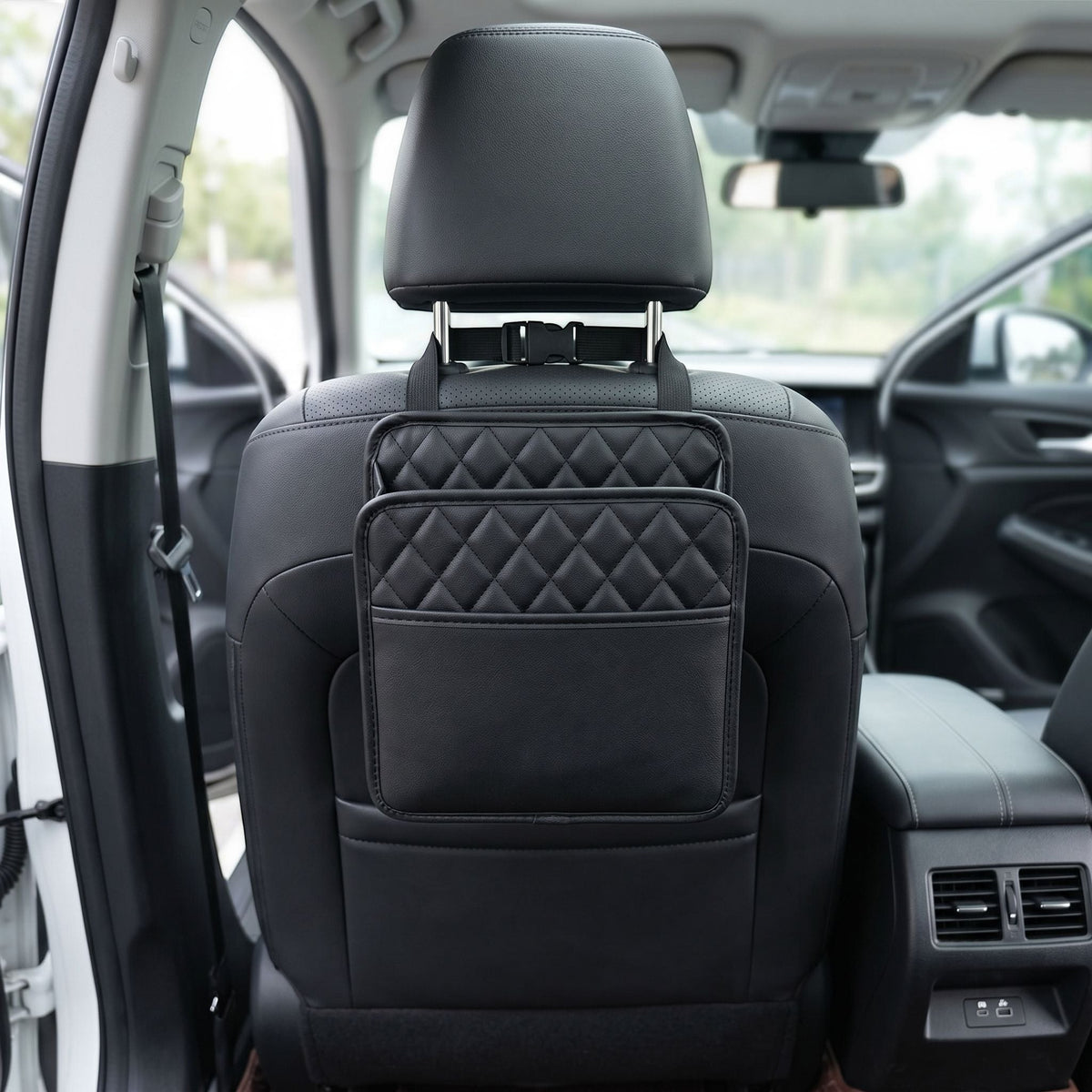 Detailed shot of a small unbranded car seat organizer highlighting textured fabric and stitching, with a blurred car interior background.
