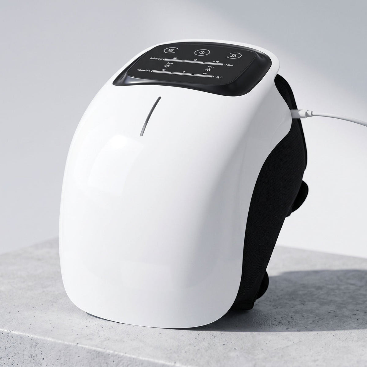 Premium cordless knee massager shown on a neutral textured surface with natural lighting highlighting ergonomic design and control buttons.