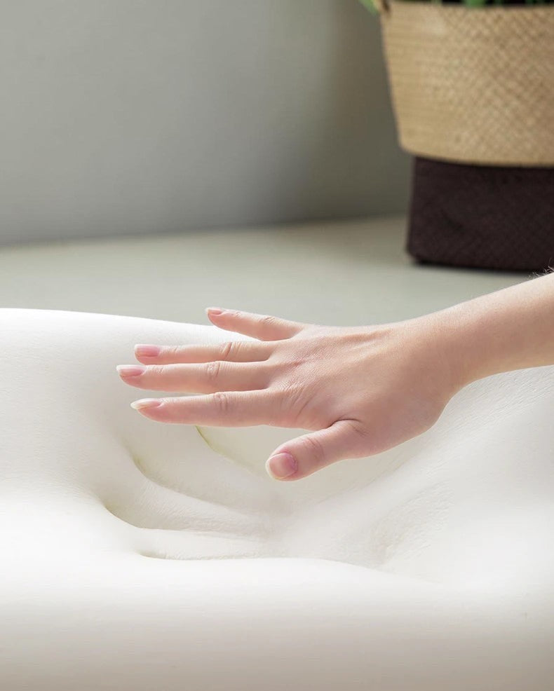 zero2cart memory foam lumbar support cushion with a hand pressing down to demonstrate soft, elastic contouring.