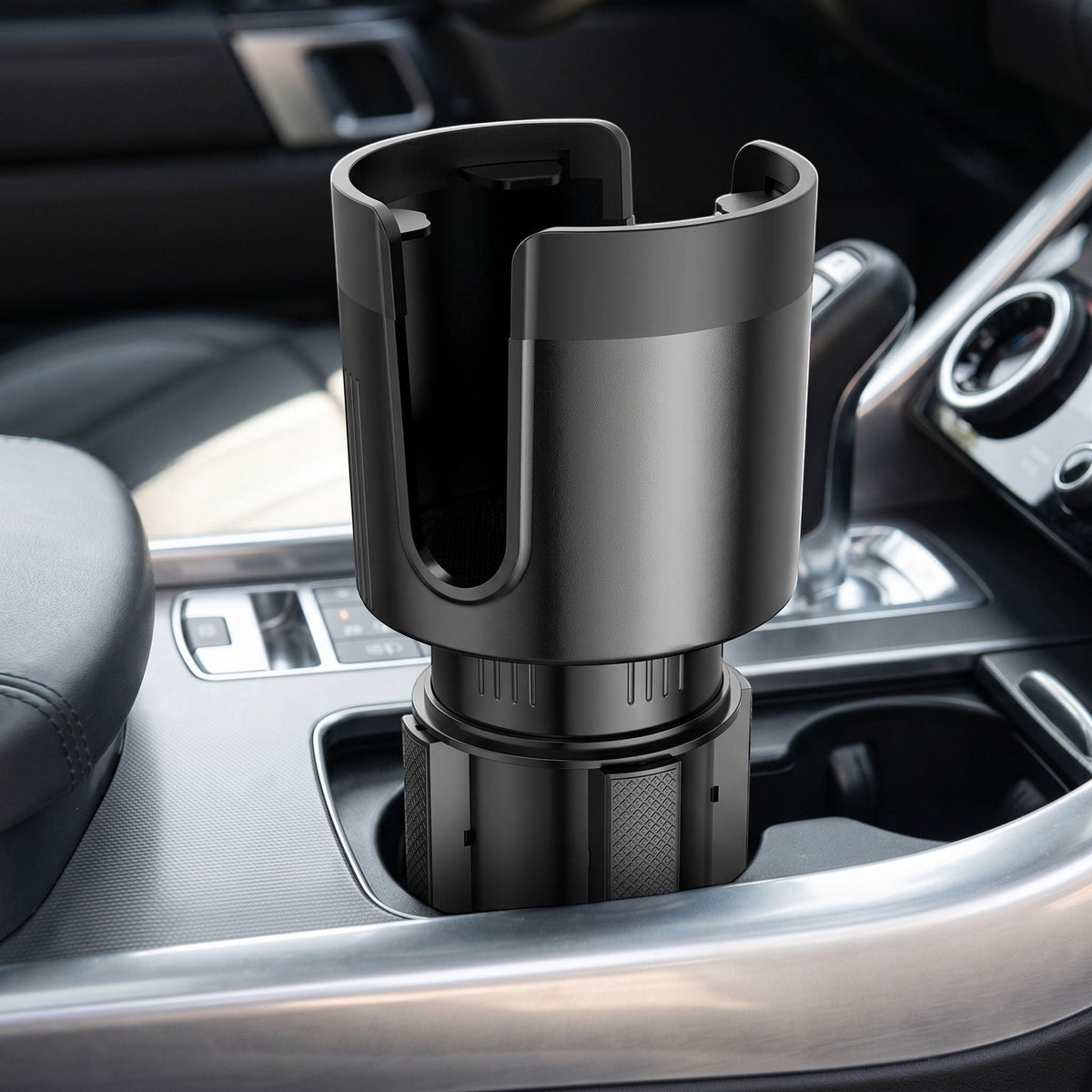 Close-up of an adjustable car cup holder extender inside a vehicle's cup holder, showing the smooth surface and anti-slip grip detail.