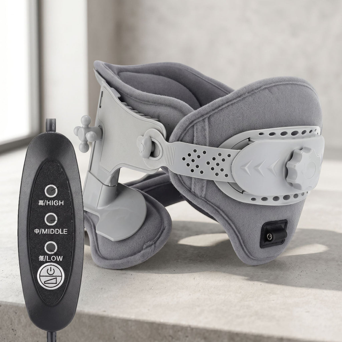 Supportive adjustable neck collar with heat settings shown on a neutral surface, highlighting its structured fabric and plastic design.