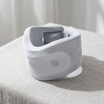 Unbranded adjustable neck support pillow with contoured shape on a neutral textured fabric surface, showcasing ergonomic design.