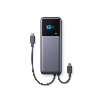 Bird's-eye view of a flat-lay of the power bank on a dark matte surface showing USB-C port and digital display.