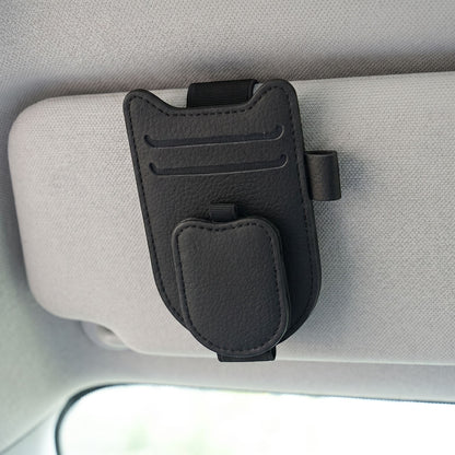Close-up view of magnetic clip and leatherette finish of sunglasses holder against textured background with soft lighting.