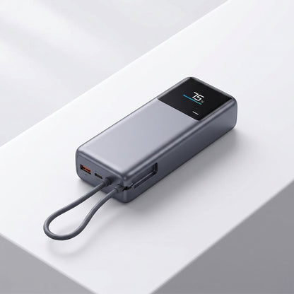 Close-up of a 165W portable power bank with digital display and built-in USB-C cable on a white surface.