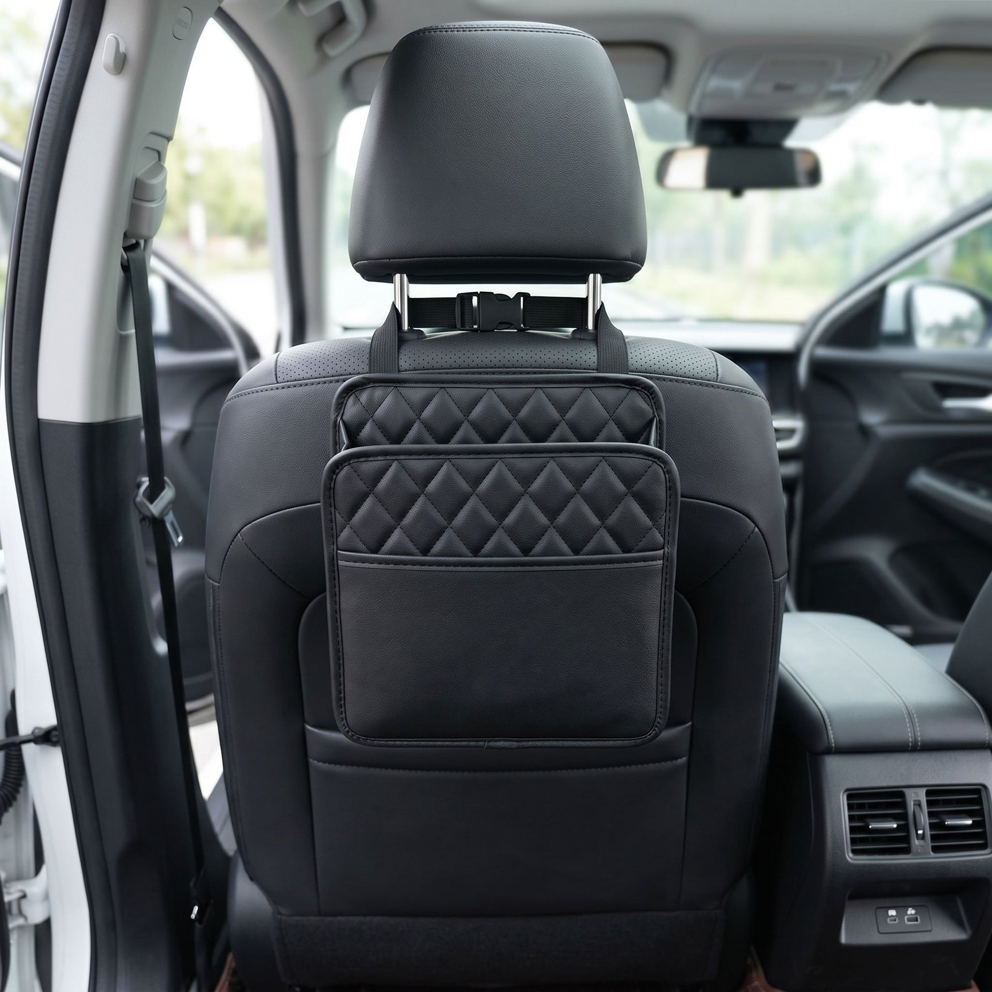 Detailed shot of a small unbranded car seat organizer highlighting textured fabric and stitching, with a blurred car interior background.