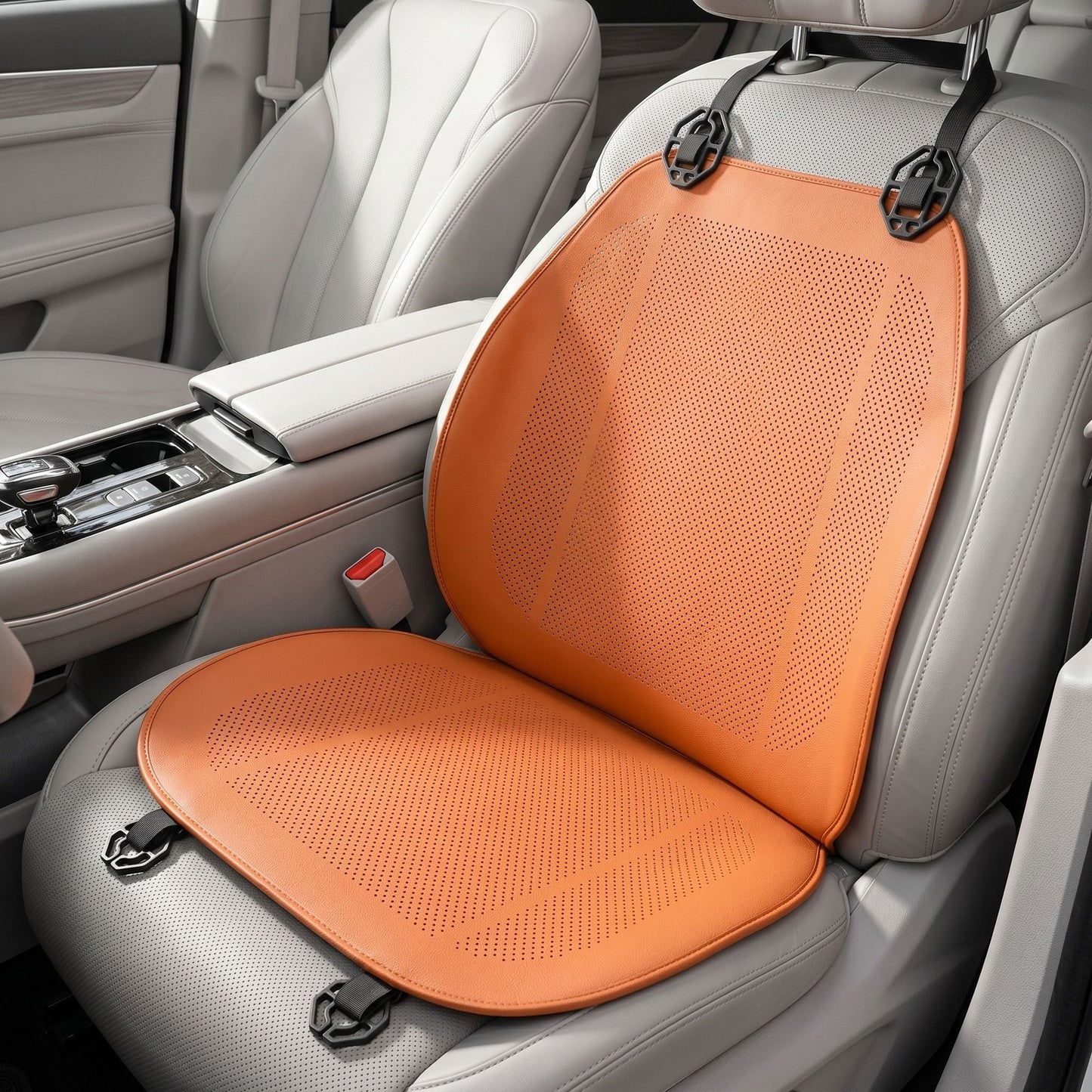 Macro close-up of a ventilated car seat cushion highlighting PVC material texture and contours, set against a blurred car interior background.