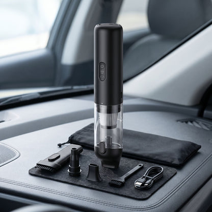 Unbranded cordless handheld vacuum cleaner placed upright on a modern car interior surface, showcasing its sleek black design and compact size.