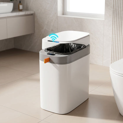 Unbranded sensor trash can placed on a bathroom or utility room floor with warm lighting and realistic shadows.