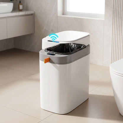 Unbranded sensor trash can placed on a bathroom or utility room floor with warm lighting and realistic shadows.
