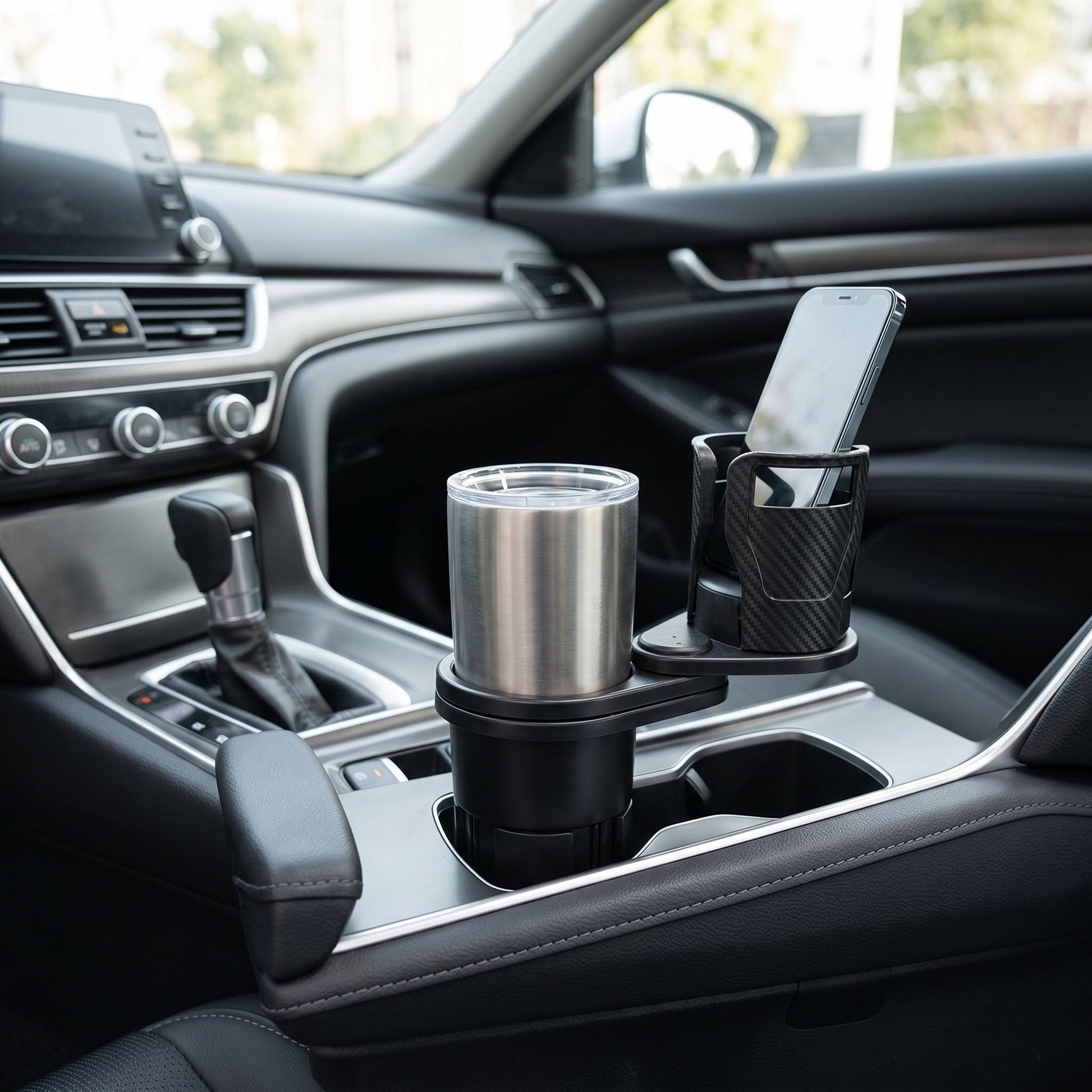 Wide shot of a sleek car interior featuring a compact dual cup holder on the center console in natural lighting.
