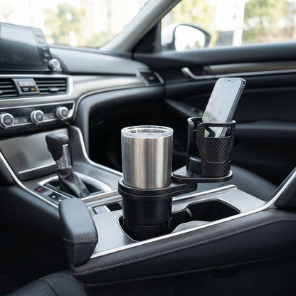 Wide shot of a sleek car interior featuring a compact dual cup holder on the center console in natural lighting.