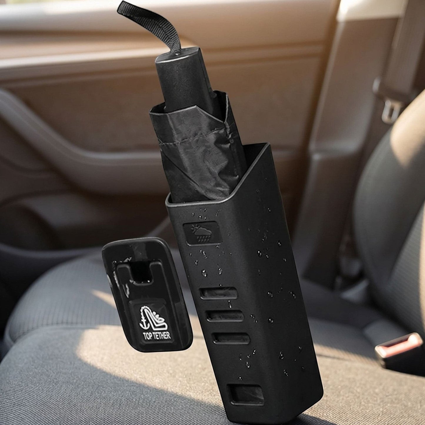 Small unbranded car umbrella holder positioned on car seat or floor, holding a wet umbrella in a realistic vehicle interior scene.