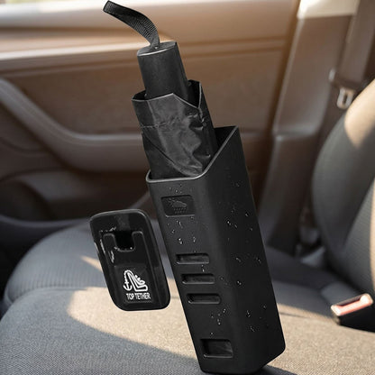 Small unbranded car umbrella holder positioned on car seat or floor, holding a wet umbrella in a realistic vehicle interior scene.