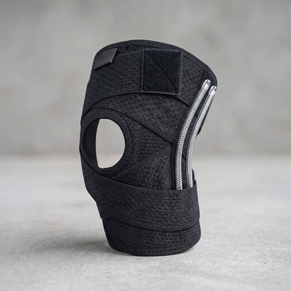 Unbranded compression knee brace with side stabilizers, adjustable straps, and breathable knit fabric, shown in a studio setting.