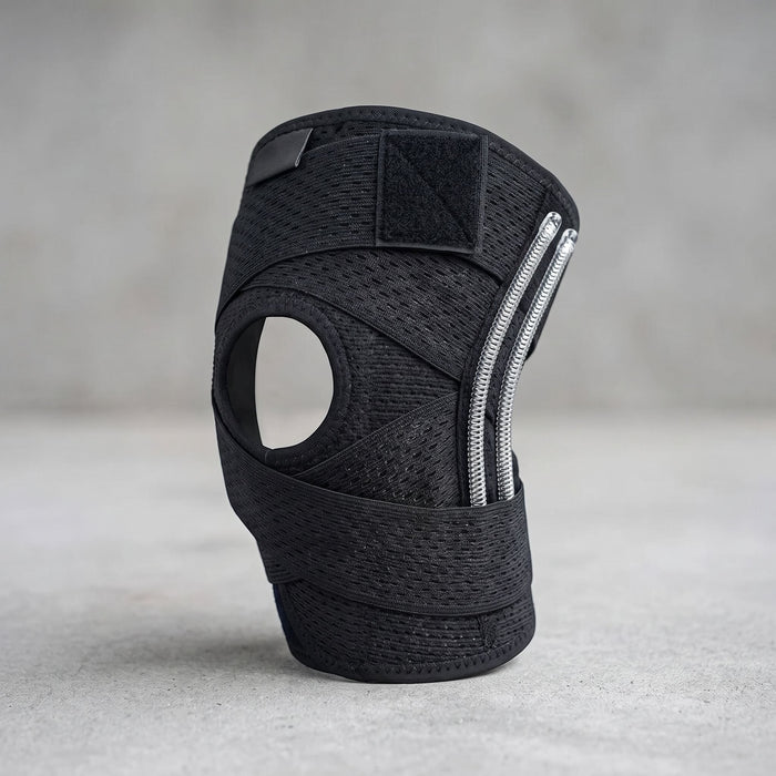 Unbranded compression knee brace with side stabilizers, adjustable straps, and breathable knit fabric, shown in a studio setting.