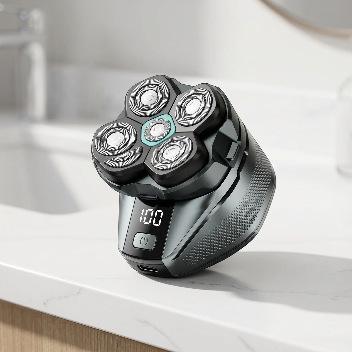Close-up of a cordless electric head shaver with stainless steel blades and LED display on a sleek white countertop.