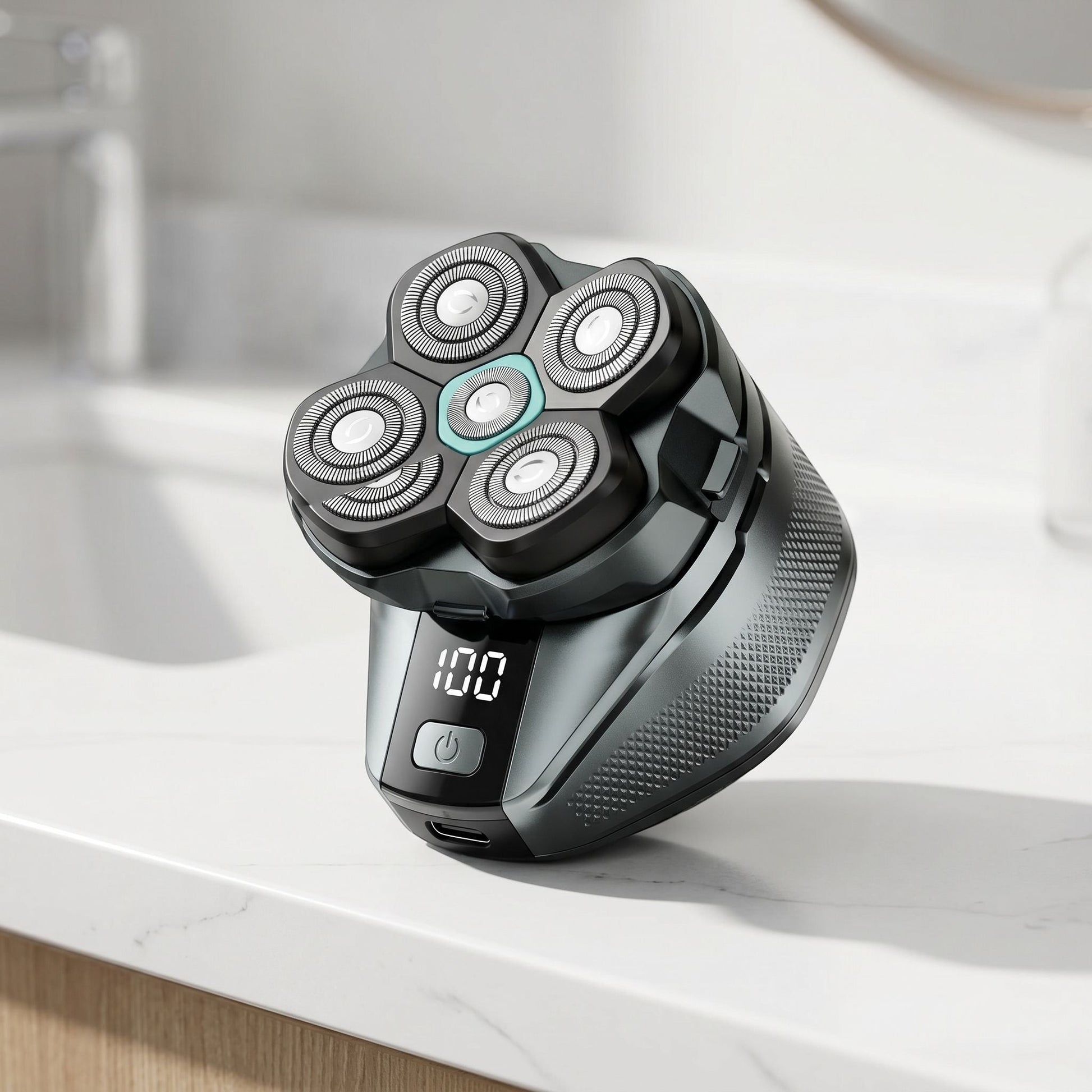 Close-up of a cordless electric head shaver with stainless steel blades and LED display on a sleek white countertop.