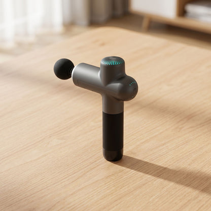 Unbranded electric massage gun on wooden surface in bright modern home, showcasing its sleek shape, ports, and buttons.