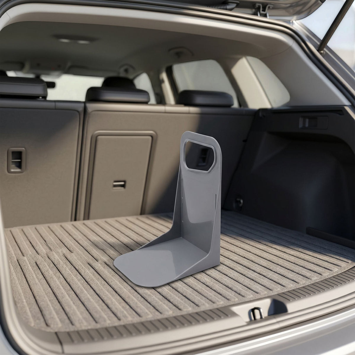 Lifestyle scene showing a small plastic trunk organizer at an angle in a car trunk with soft sunlight highlighting its shape and material.
