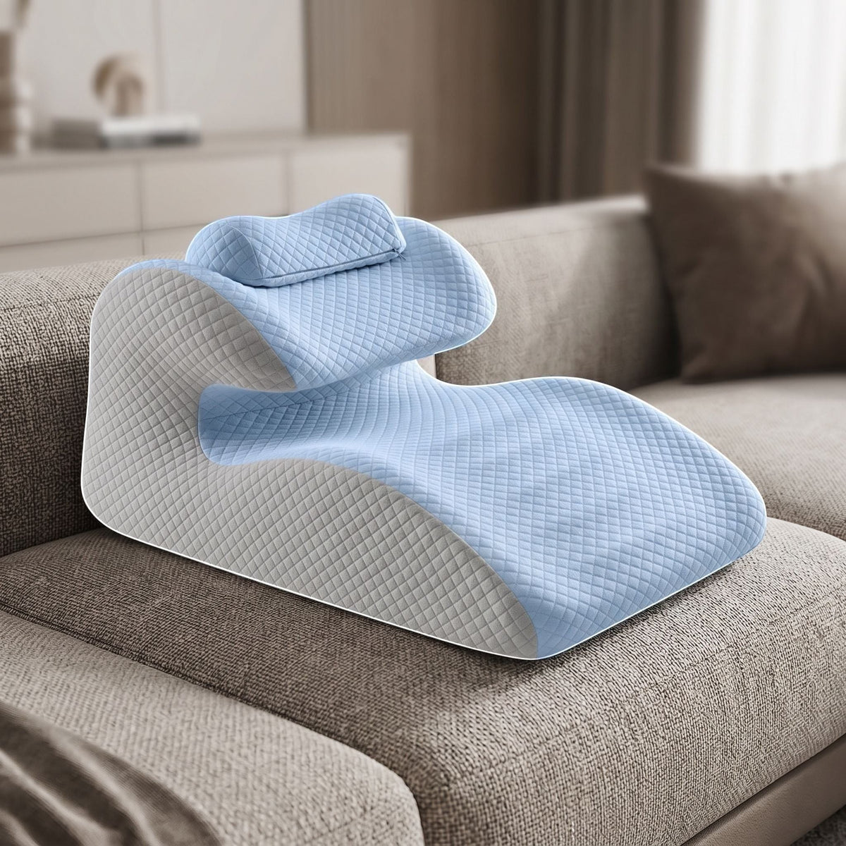 Support pillow resting on a contemporary sofa, showcasing its ergonomic shape and smooth surface in a warm living room setting.