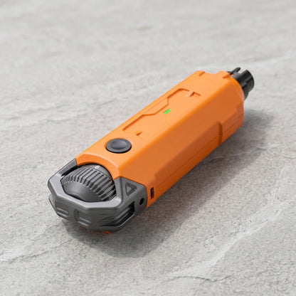 Compact rechargeable dog nail grinder with ergonomic design and USB charging port, showcased on a neutral textured surface for ecommerce.