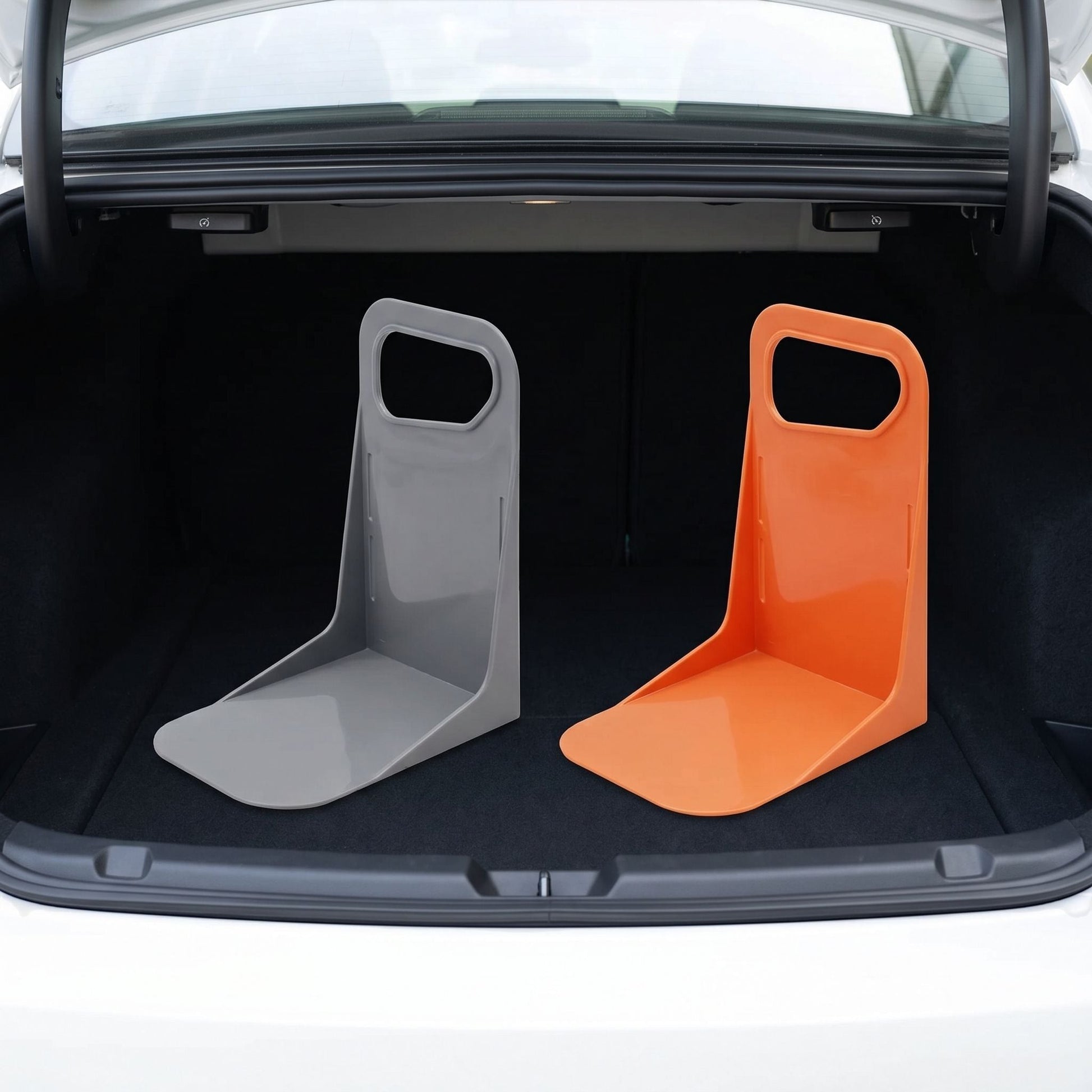 Centered view of a small, unbranded plastic car trunk organizer with anti-slip bottom in a tidy car trunk environment.