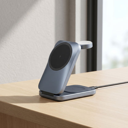 Foldable 3-in-1 wireless charging station on a sleek desk, showing phone, watch, and earbuds charging in natural light.