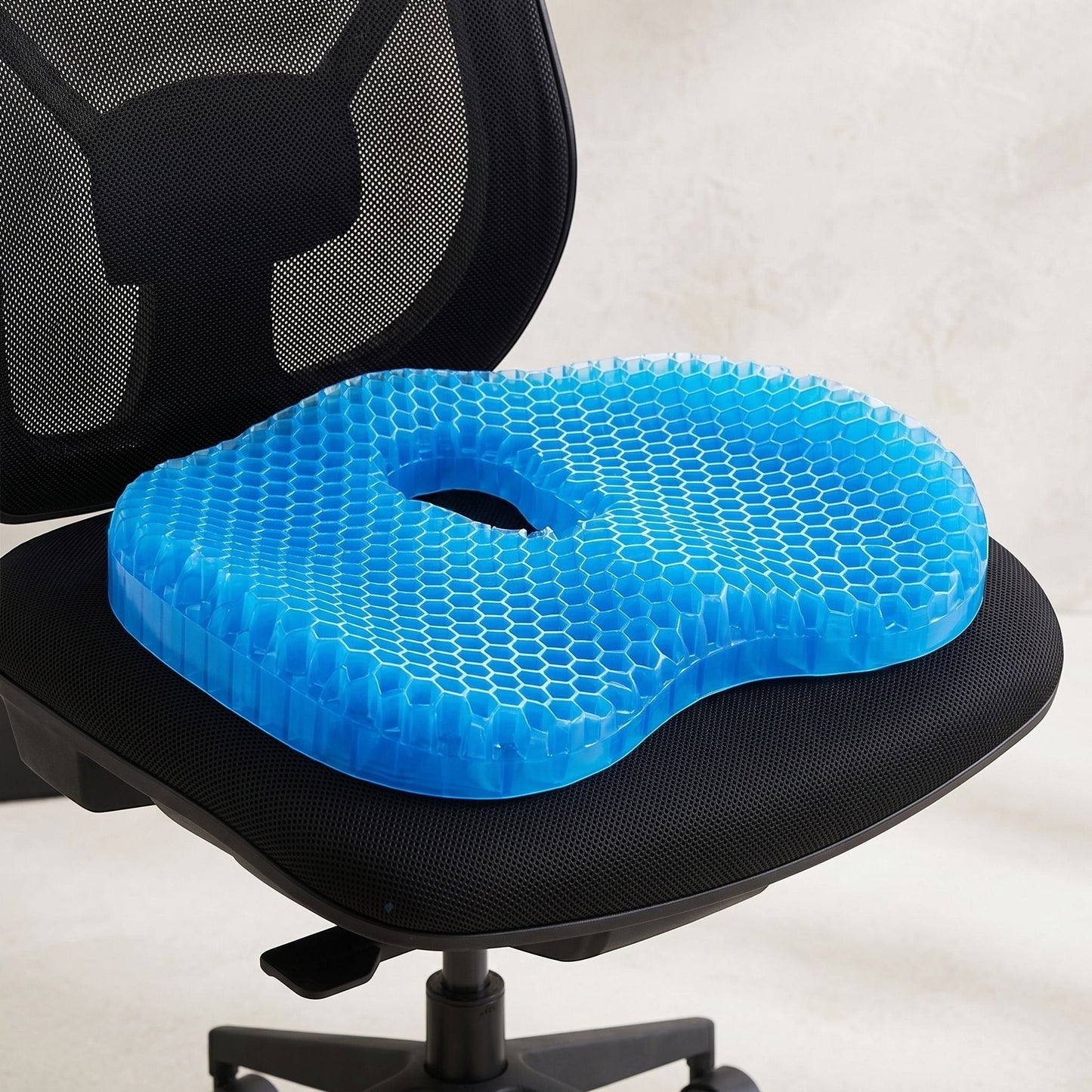 Comfortable U-shaped seat cushion on modern office chair with breathable surface and washable cover, highlighting support and cooling features.