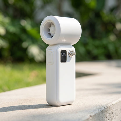 Outdoor scene with a white turbo fan on a concrete surface, sunlight highlighting its metallic and plastic finishes.