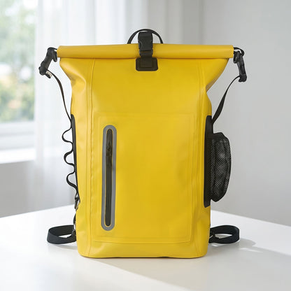 Dry bag backpack placed on textured wooden surface, showing waterproof material, side mesh pocket, and front waterproof zipper in natural outdoor lighting.