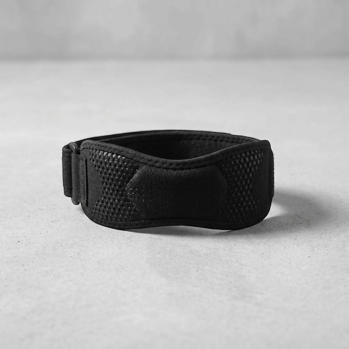Neutral background with focus on a centered knee strap showcasing knit texture and elasticity.