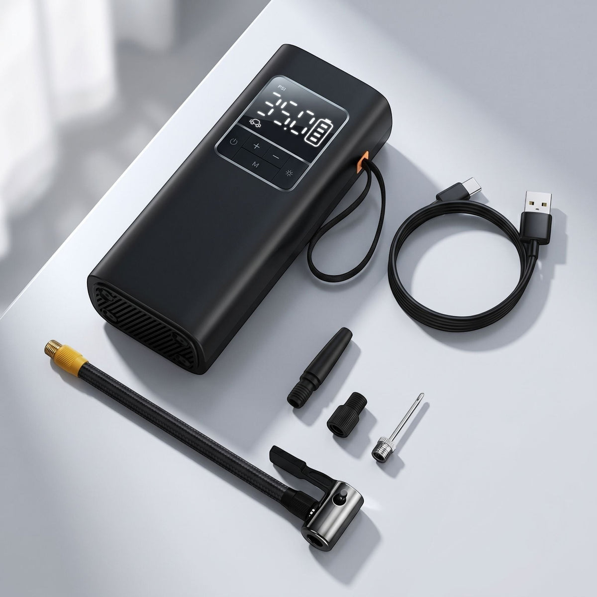 Unbranded portable digital tire inflator air pump with LCD display showing pressure, centered on a matte surface in a studio setting.