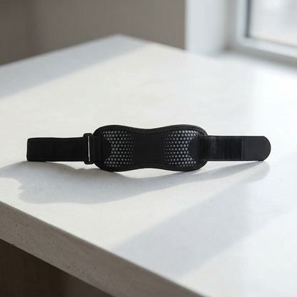 Knee strap laid flat on modern surface with natural lighting emphasizing material and texture.