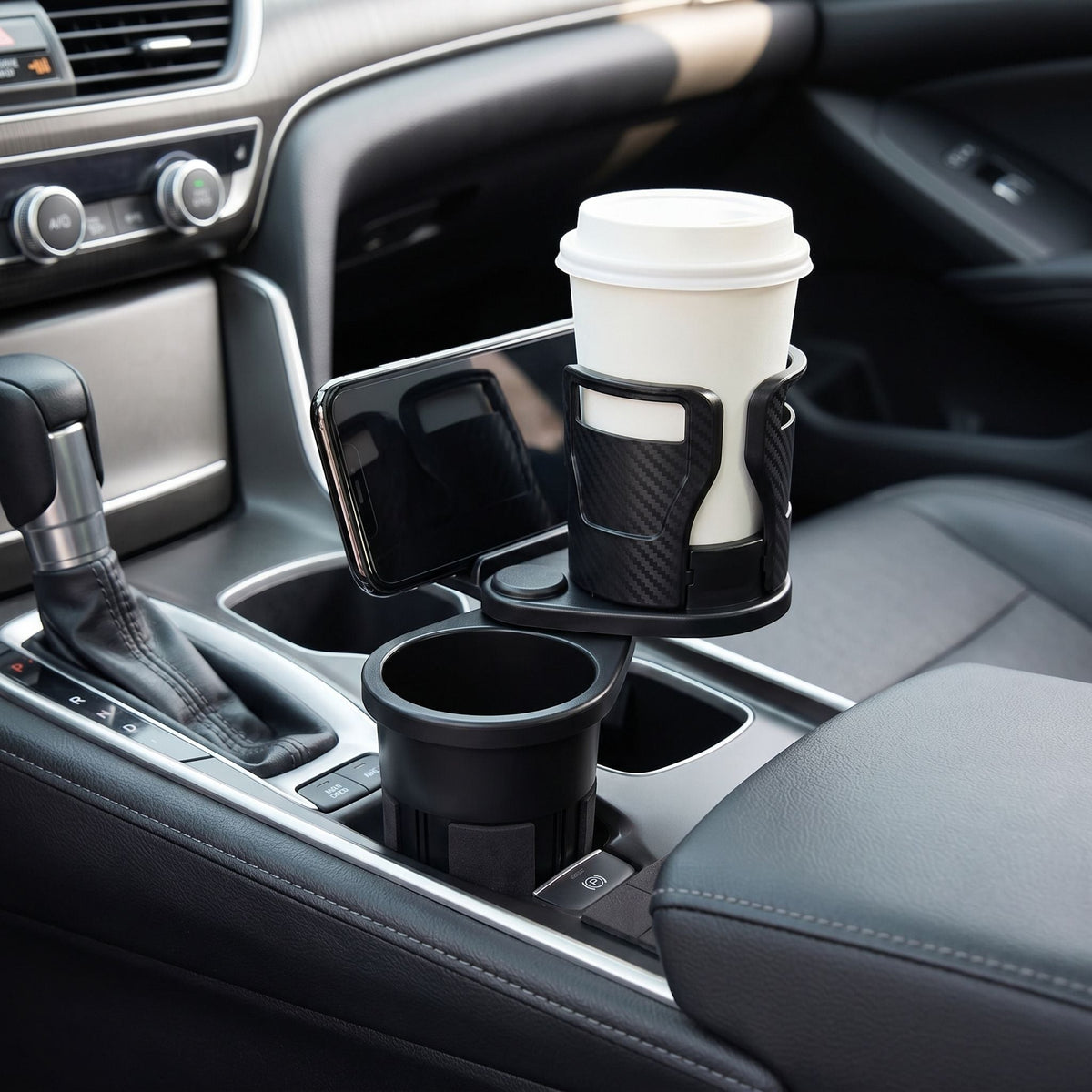 Detailed view of a dual cup holder with phone stand installed in a car, highlighting anti-slip pads and shock absorption.