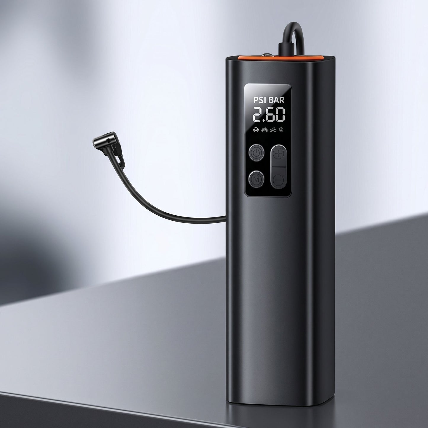 Close-up of a small tire inflator on a reflective surface, highlighting its ports, pressure display, and realistic plastic texture.