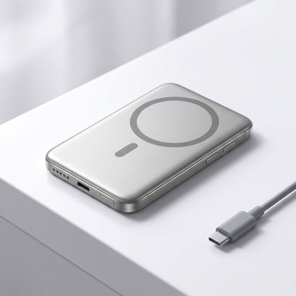 Realistic studio shot of a slim magnetic wireless power bank on a white surface, highlighting its shape and ports.