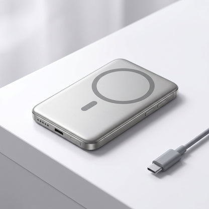 Realistic studio shot of a slim magnetic wireless power bank on a white surface, highlighting its shape and ports.