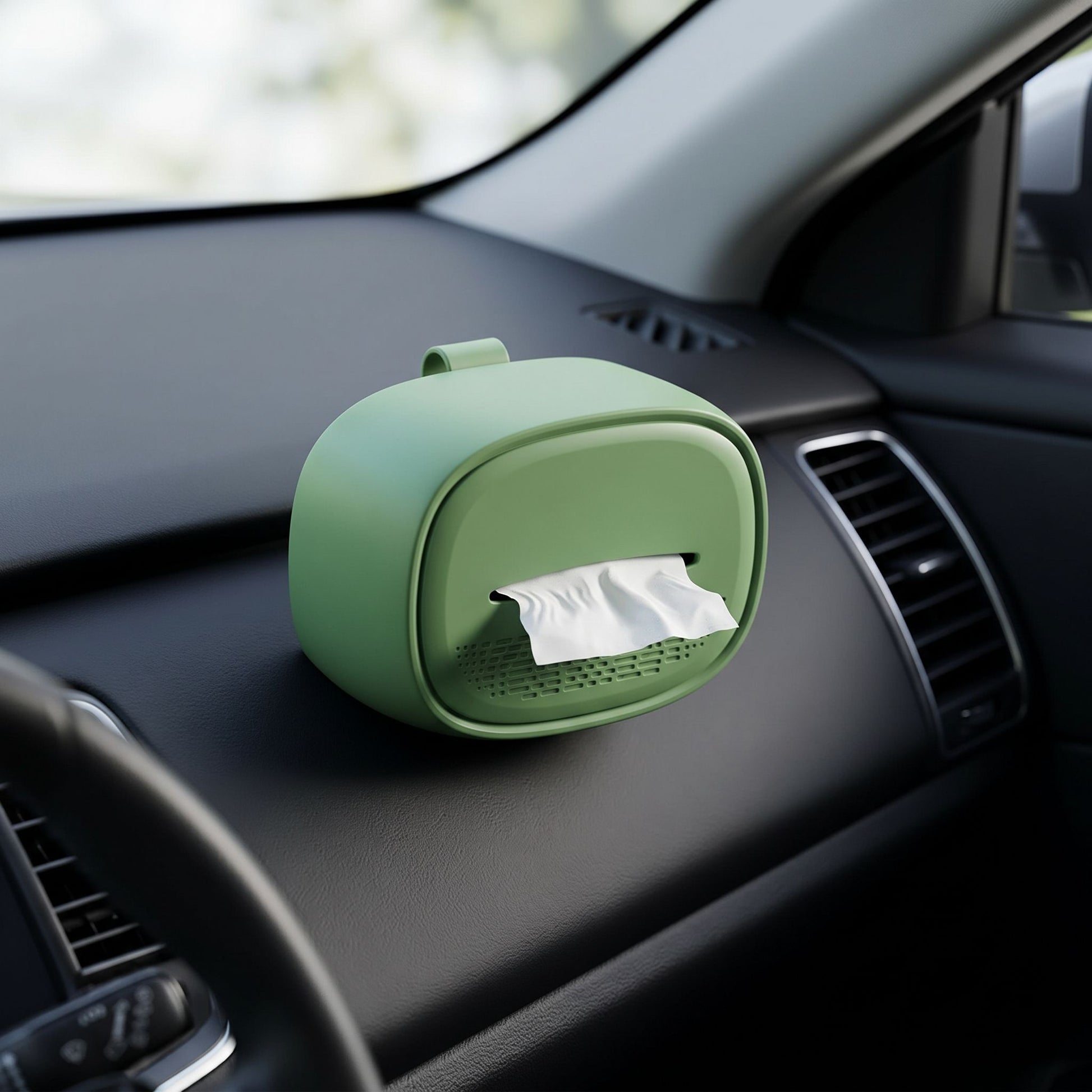 Close-up of a small silicone hanging car tissue holder with a neutral color, attached inside a modern car interior.