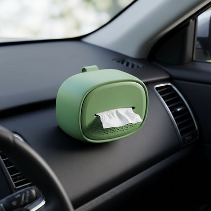 Close-up of a small silicone hanging car tissue holder with a neutral color, attached inside a modern car interior.