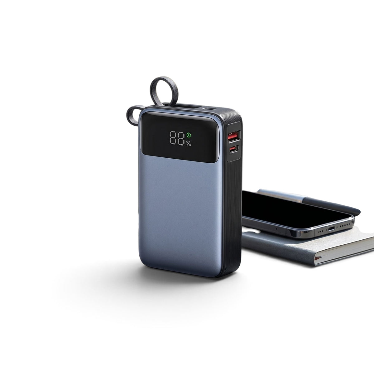 Travel-friendly 65W power bank placed on a backpack in an outdoor urban setting with natural light.