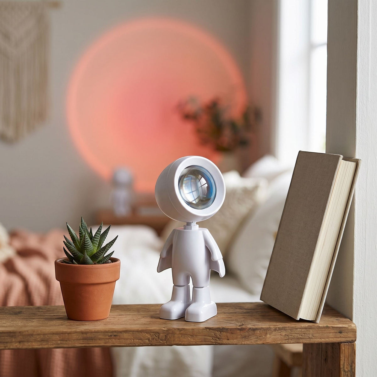 zero2cart rechargeable astronaut sunset projection lamp casting a warm circular glow on a bedroom wall