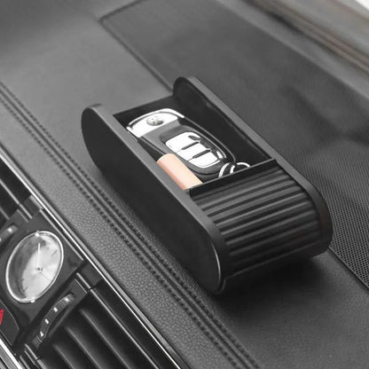 zero2cart black telescopic car dashboard storage box holding keys and coins on a vehicle console