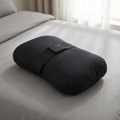 zero2cart black side sleeper knee pillow with an adjustable strap resting on a grey bed sheet