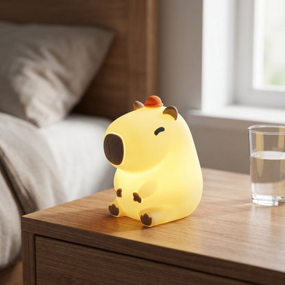 zero2cart rechargeable capybara night light with a soft silicone body glowing warmly on a wooden bedside table
