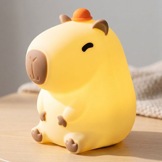 zero2cart rechargeable capybara night light with a soft silicone body, warm LED glow, and a small orange hat.