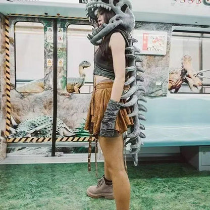 zero2cart dinosaur skeleton costume featuring a grey plush headpiece and spine tail worn by a woman in a subway car
