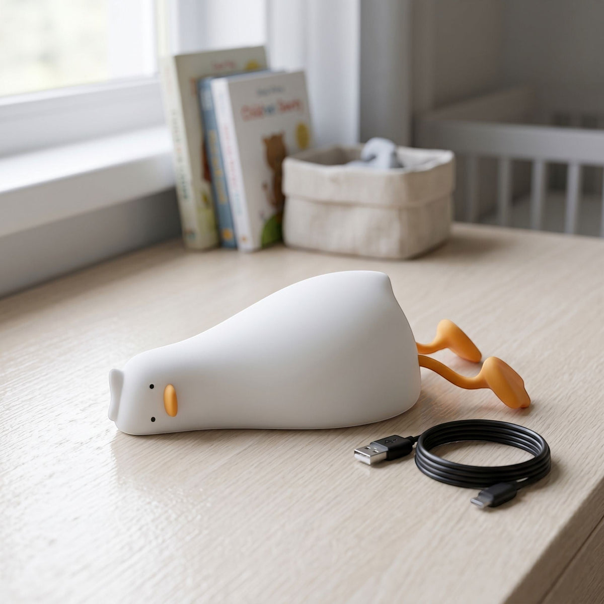 zero2cart rechargeable duck night light in soft white silicone with orange feet on a wooden nursery desk