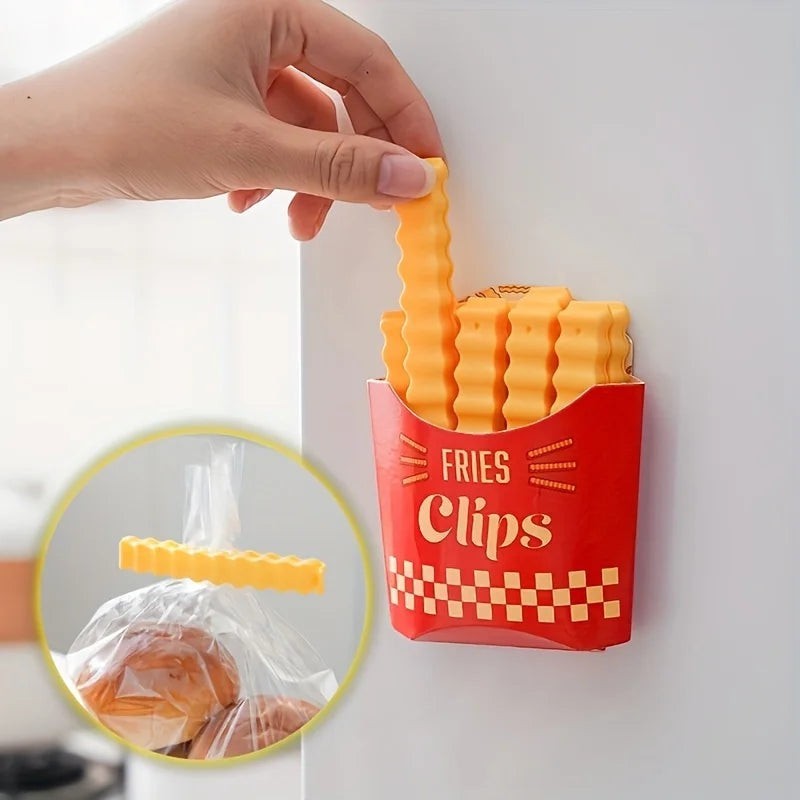 zero2cart French fry shaped plastic bag sealing clips in a red holder attached to a refrigerator surface
