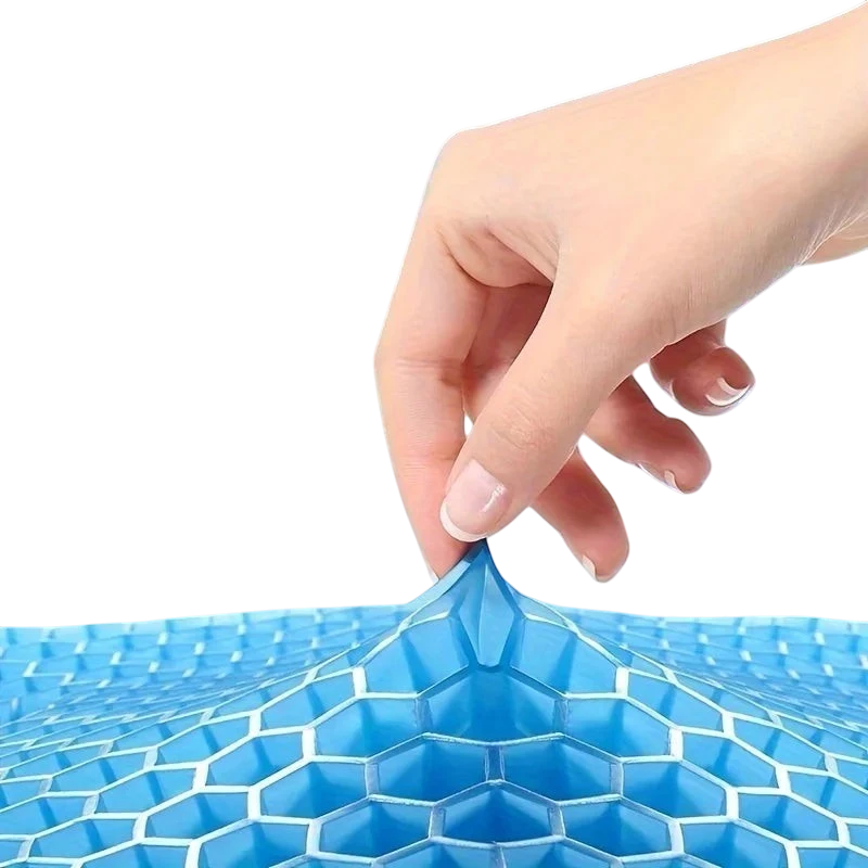A hand pulling on a blue zero2cart gel seat cushion with a flexible honeycomb structure for cooling support.